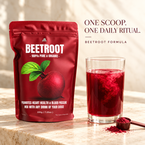 A red stand-up pouch of Beetroot Formula powder stands on a light stone surface beside a clear glass filled with deep red liquid, a small spoon of powder, and marketing text reading 'ONE SCOOP. ONE DAILY RITUAL.
