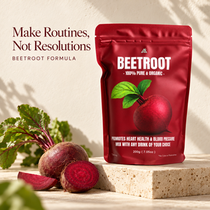 A red stand-up pouch of Beetroot Formula drink mix stands on a stone block with whole and sliced beetroots and green leaves beside it. Text on the left reads 'Make Routines, Not Resolutions' and 'BEETROOT FORMULA'.