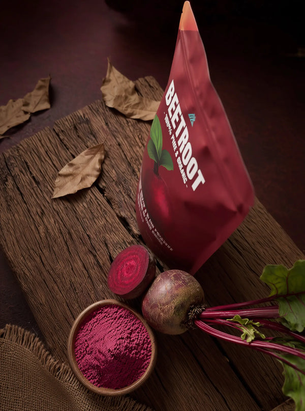 Bag of beetroot powder with fresh beets on a wooden surface